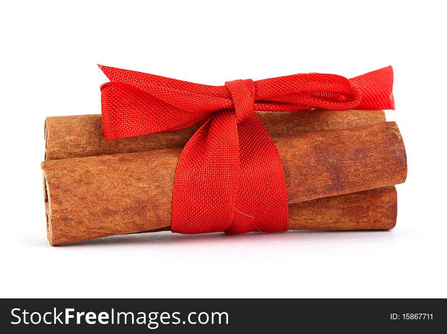 Cinnamon with red ribbon for Christmas isolated on white