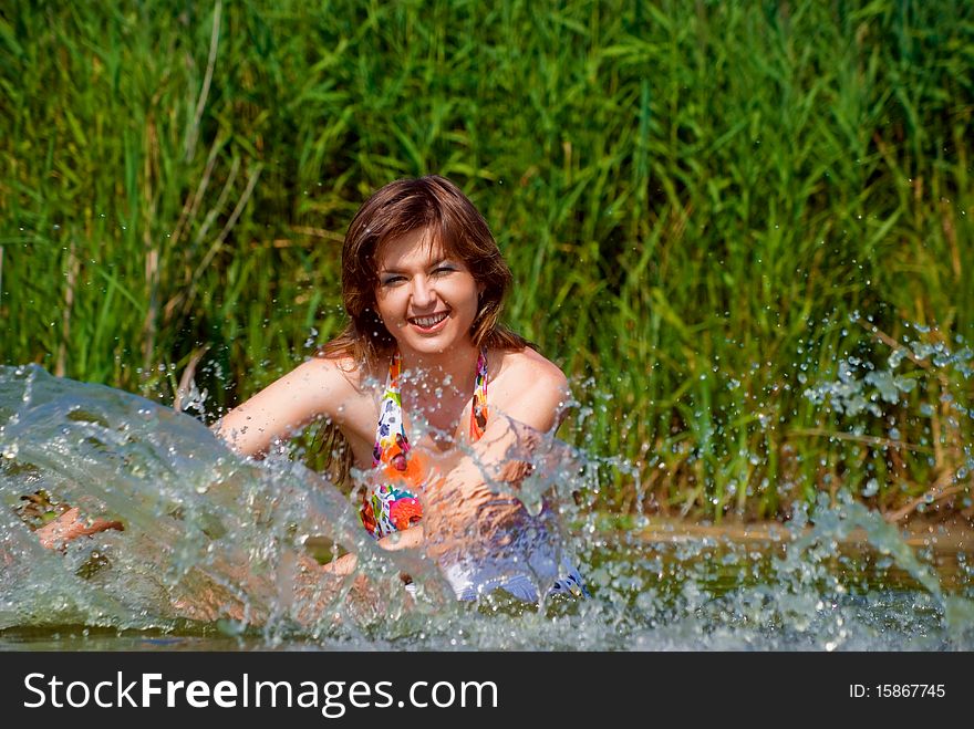 Beautiful girl playing in water. Beautiful girl playing in water