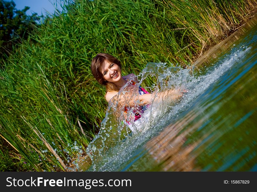 Beautiful girl playing in water. Beautiful girl playing in water