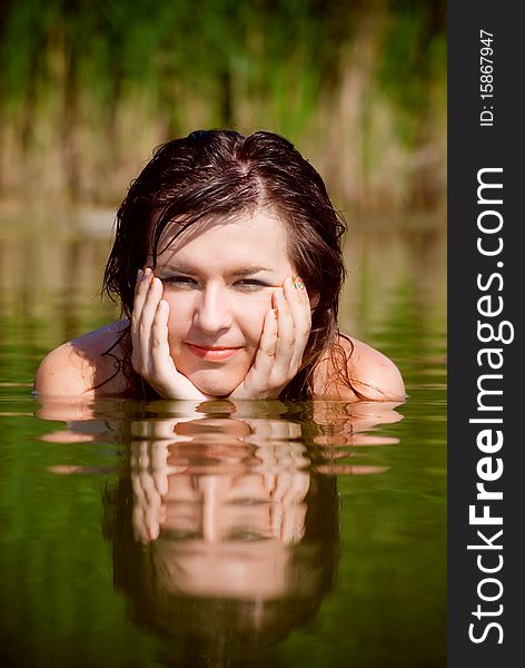 Beautiful girl in sarafan awash in water. Beautiful girl in sarafan awash in water