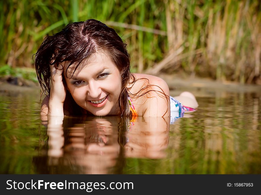 Beautiful girl in sarafan awash in water. Beautiful girl in sarafan awash in water