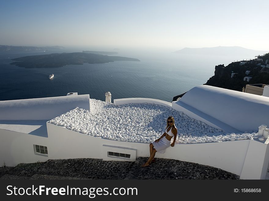 Young woman admires the sunset in Santorini, Greece. Young woman admires the sunset in Santorini, Greece