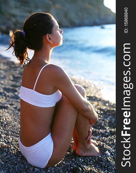 Woman meditating on the beach.