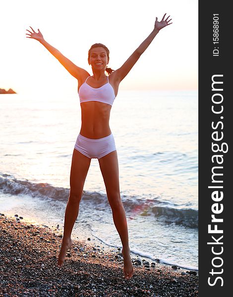 Beautiful brunette is happy on the beach. Beautiful brunette is happy on the beach.