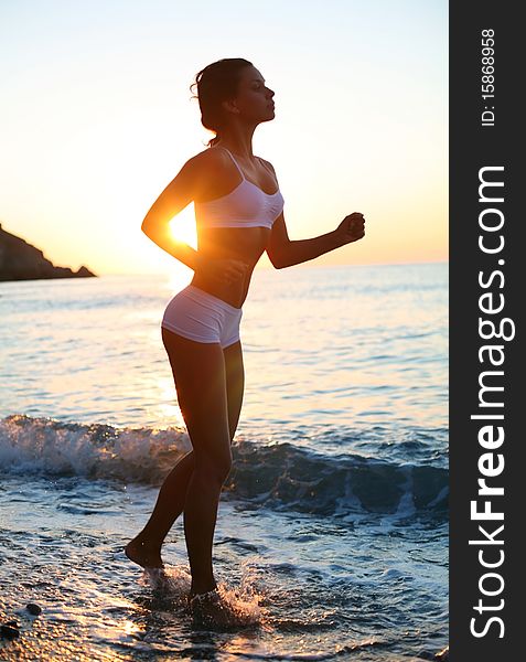 Girl is running on the beach