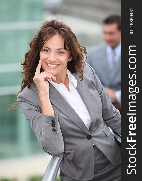 Portrait of businesswoman standing in front of businessemen. Portrait of businesswoman standing in front of businessemen