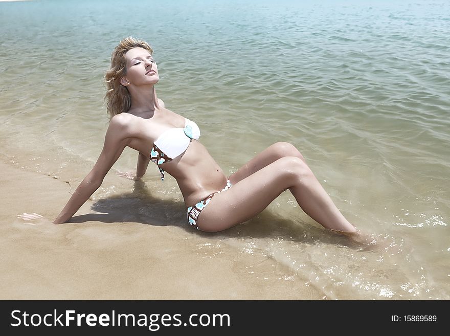Beautiful woman in bikini on the beach. Beautiful woman in bikini on the beach