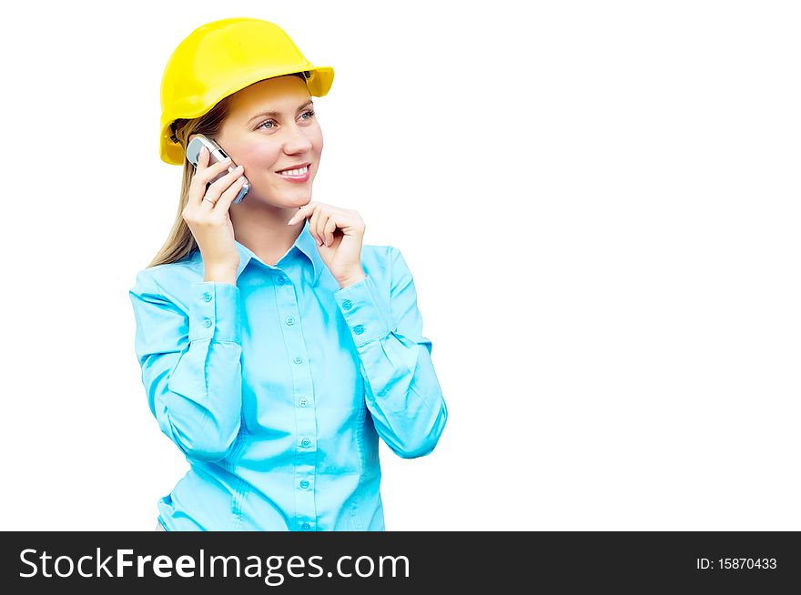 Young architect wearing a protective helmet standing on the building background