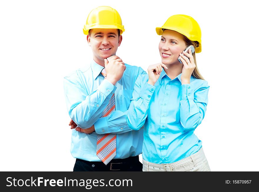 Young architects wearing a protective helmet standing on the building background