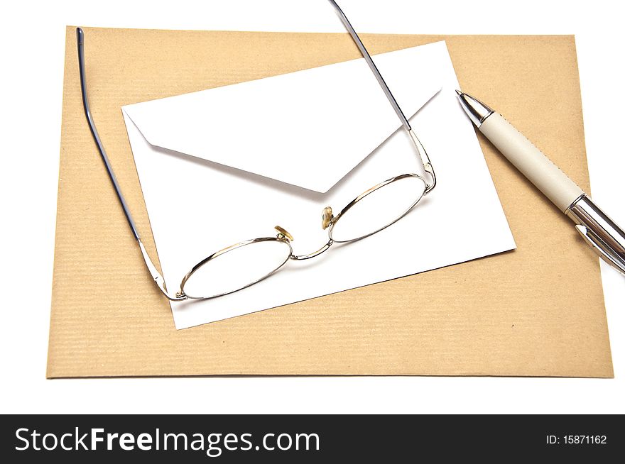 Pen envelope and glasses isolated on white