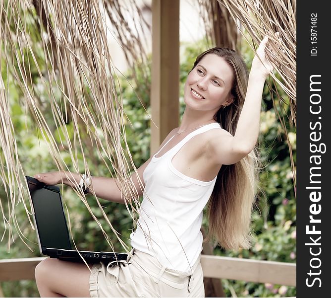 Beautiful young woman outdoors in the summer day.