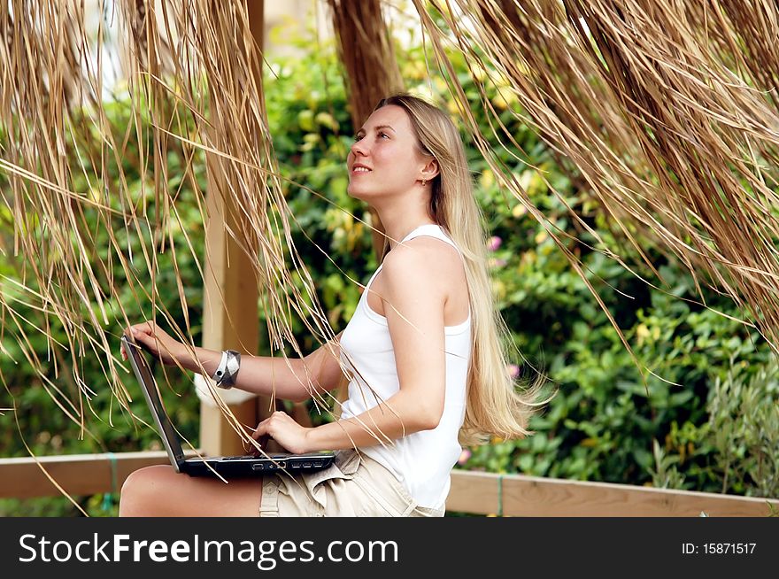 Beautiful young woman outdoors in the summer day.