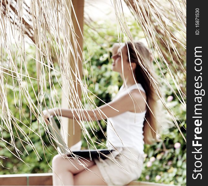 Beautiful young woman outdoors in the summer day.