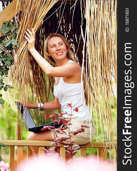 Beautiful young woman outdoors in the summer day.