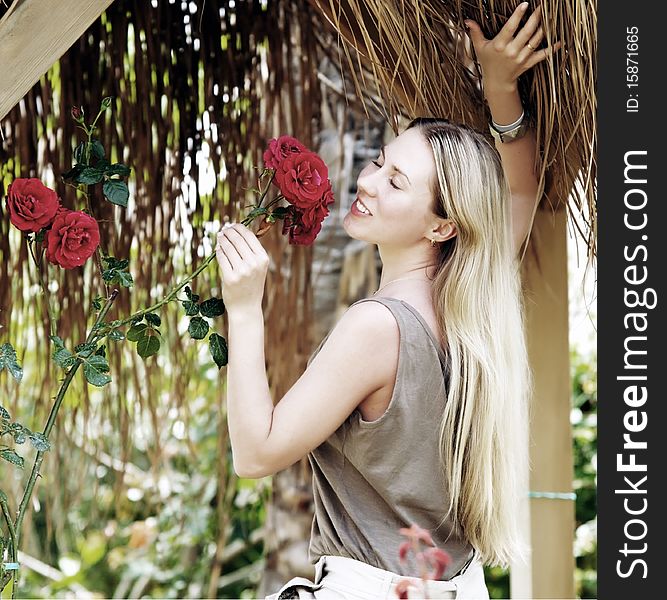 Beautiful young woman outdoors in the summer day.