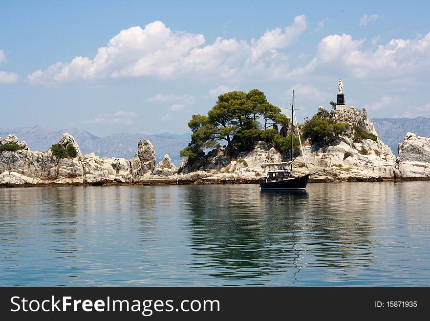 Landscape in the port Trpanj with white rocks and Statue of Holy Lady. Landscape in the port Trpanj with white rocks and Statue of Holy Lady