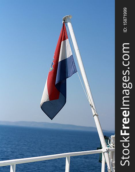 Croatian flag on the ferry against blu sky