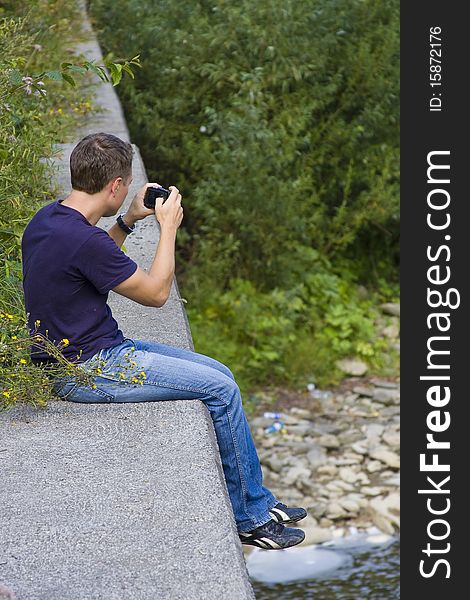 Man making a photo on his compact photocamera. Man making a photo on his compact photocamera
