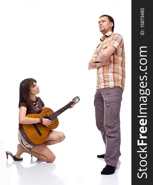 Girl plays the guitar for a boy on a white background