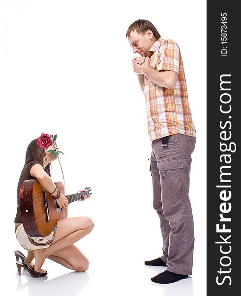 Girl plays the guitar for a boy on a white background