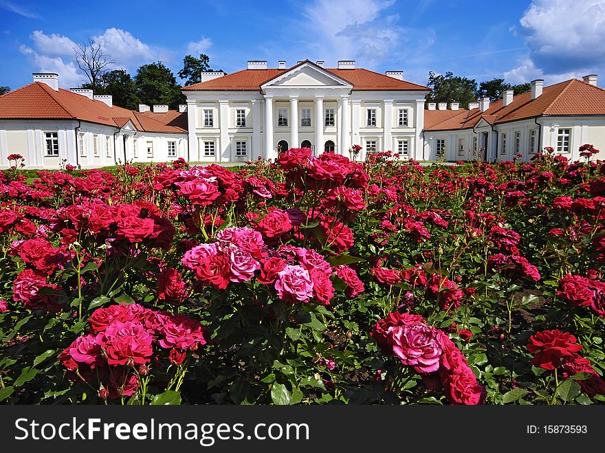 Classical palace with the garden into a sunny day
