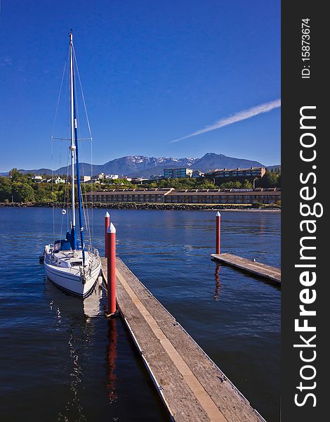 A Sailing Boat with Mountains and Water. A Sailing Boat with Mountains and Water