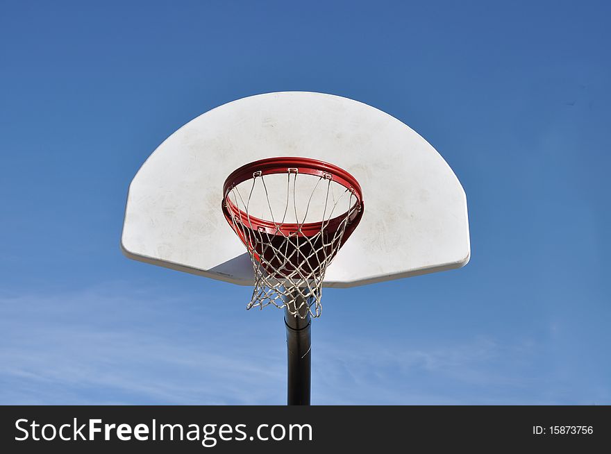 Close up of basketball hoop under clear blue sky. Close up of basketball hoop under clear blue sky