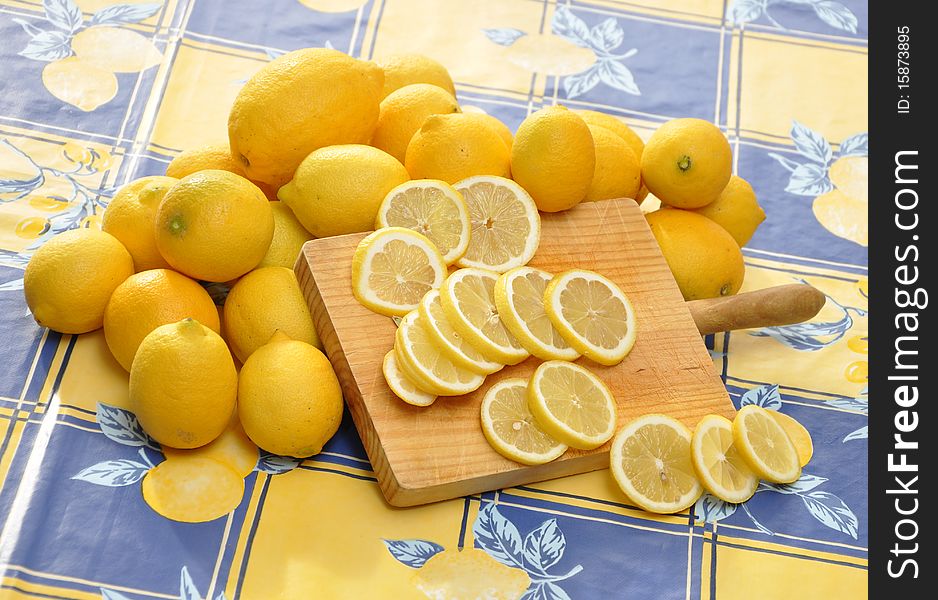 Whole lemons and slices on tablecloth. Whole lemons and slices on tablecloth