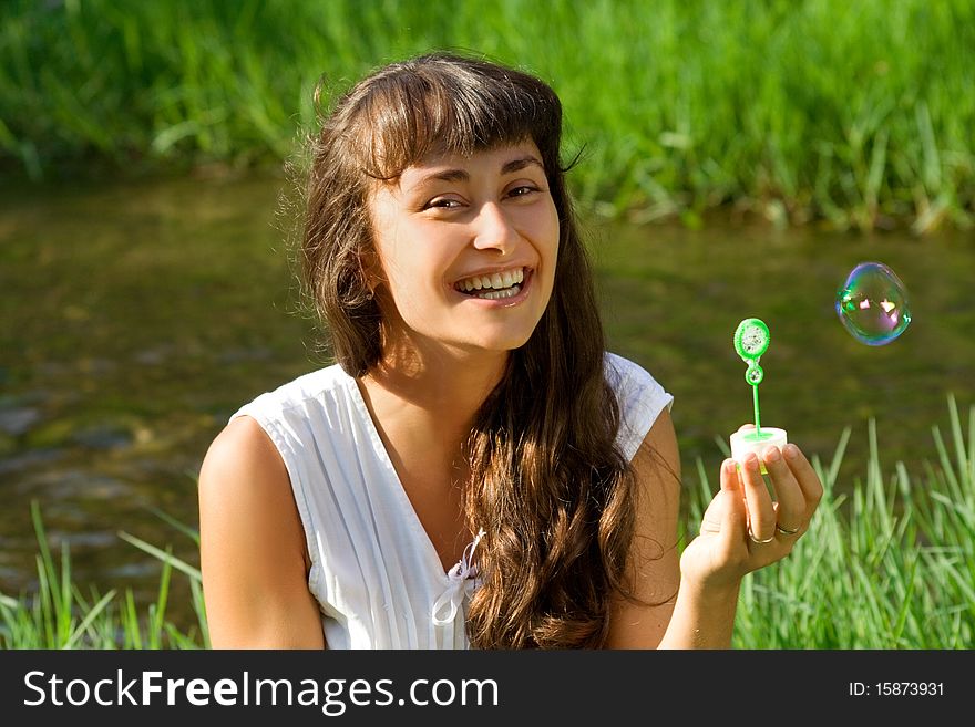 Happy smiling girl outdoors with colorful bubble. Happy smiling girl outdoors with colorful bubble