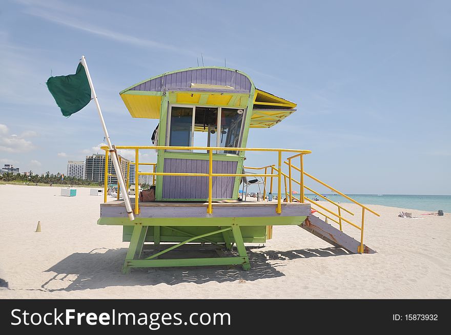 Green life guard station flag waving perfect beach day. Green life guard station flag waving perfect beach day