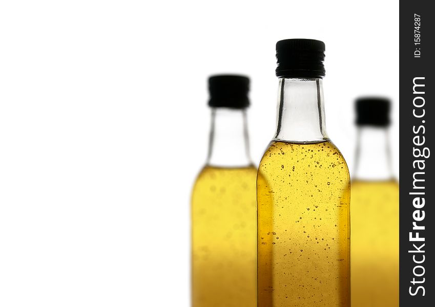 Three bottles of a yellow fizzy drink, isolated on white background, with a shallow depth of field. Three bottles of a yellow fizzy drink, isolated on white background, with a shallow depth of field.