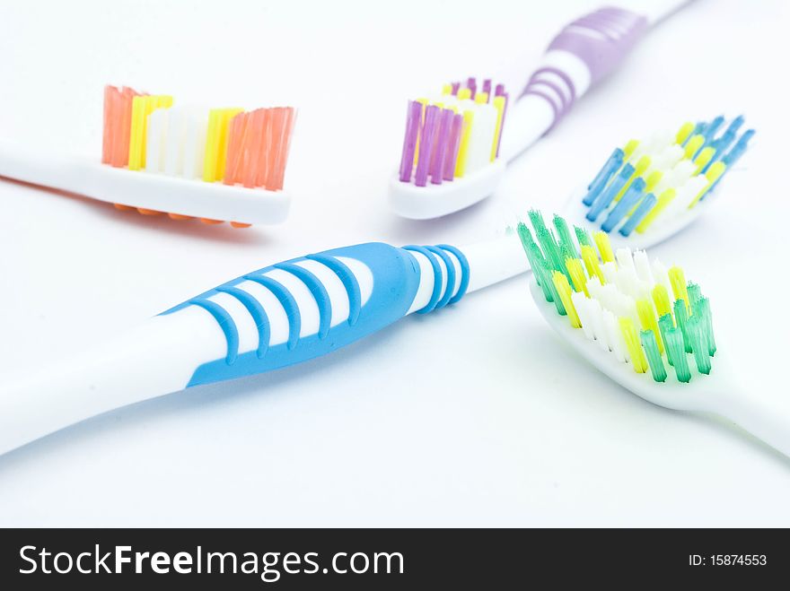 Colourful toothbrushes on the white background