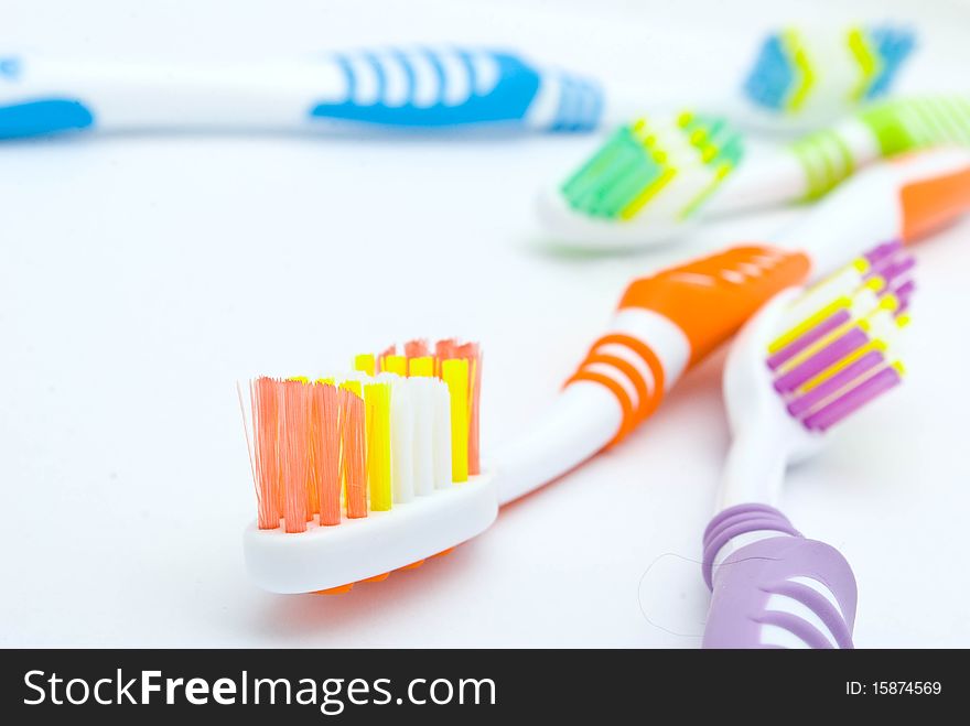 Colourful toothbrushes on the white background