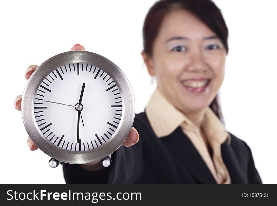 An Asian businesswoman holding a clock. Focus is on the clock. An Asian businesswoman holding a clock. Focus is on the clock