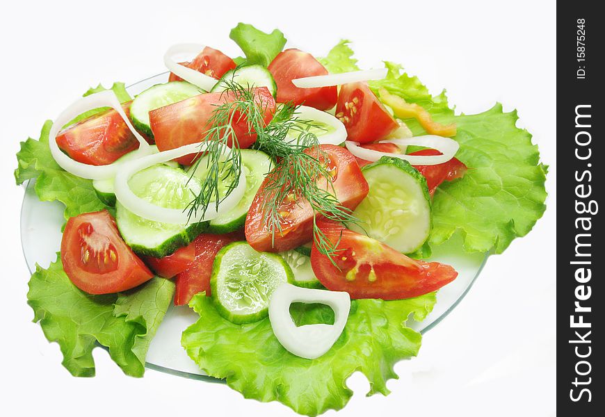 Vegetable salad with tomato cucumber and onion on lettuce