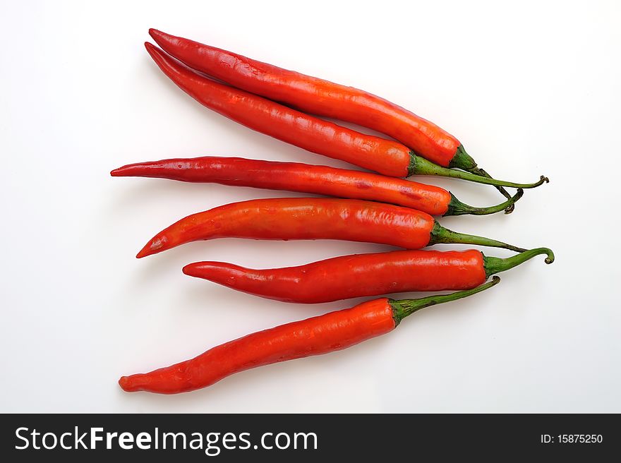 Red hot chili peppers in white background.