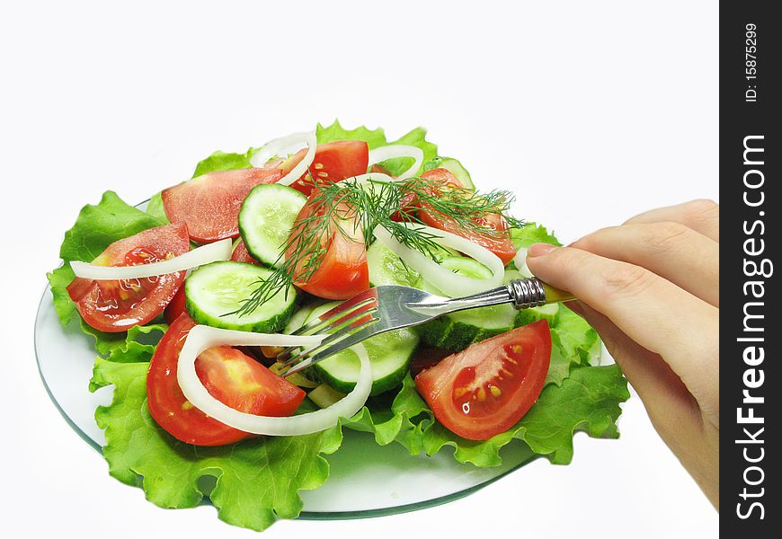 Vegetable salad with tomato cucumber and hand with fork