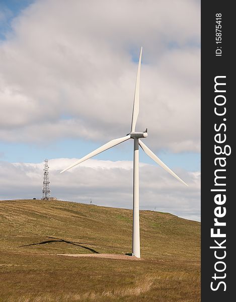 Wind turbine on a wind farm in Scotland, Europe close to a mobile phone transmitter mast. Wind turbine on a wind farm in Scotland, Europe close to a mobile phone transmitter mast.