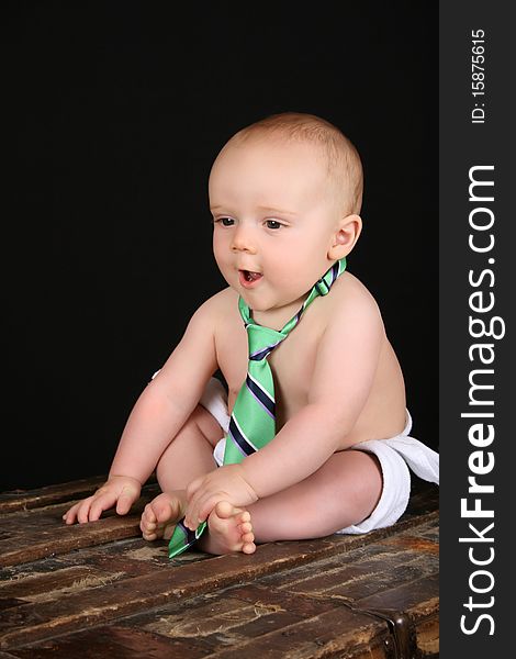 Cute caucasian baby wearing just a tie and diaper. Cute caucasian baby wearing just a tie and diaper