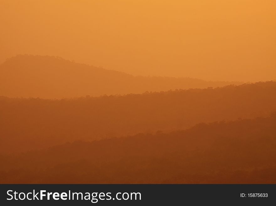 Mountain range with cover by the light of sunset