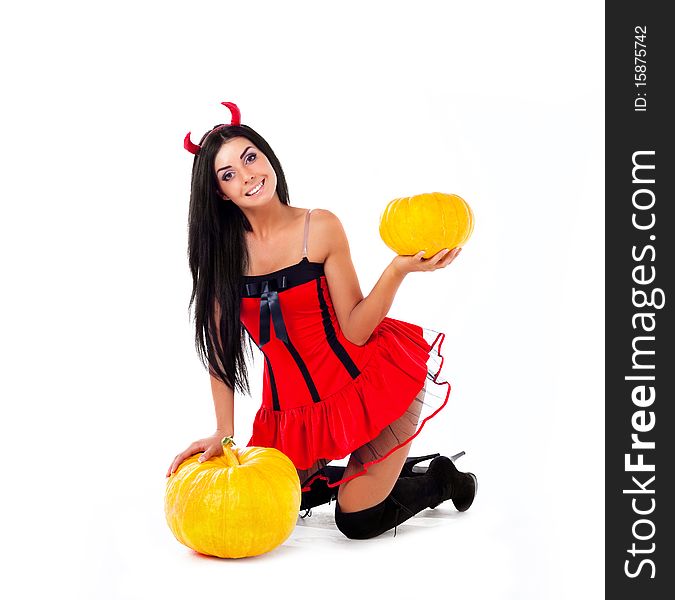 Sexy young brunette woman dressed as an imp with a pumpkin. Sexy young brunette woman dressed as an imp with a pumpkin