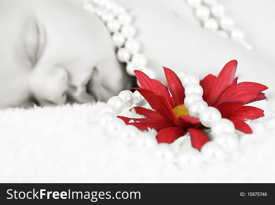 Beautiful baby girl sleeping, pearls draped with flower. FOCUS ON FLOWER AND PEARLS. Beautiful baby girl sleeping, pearls draped with flower. FOCUS ON FLOWER AND PEARLS.