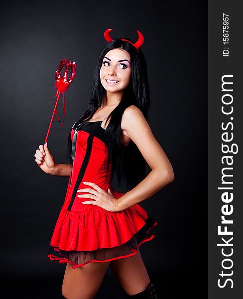 brunette girl wearing a halloween costume of an imp