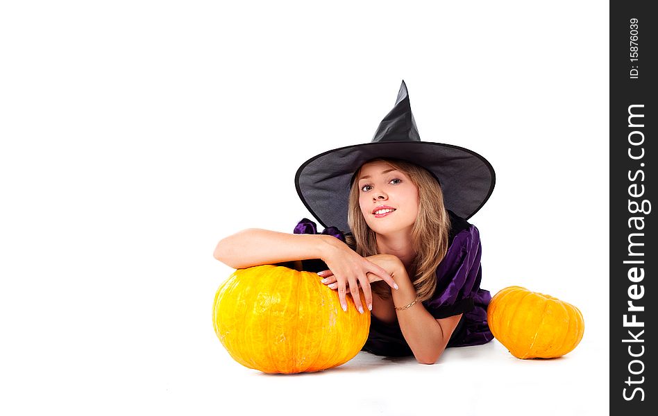 Pretty young blond woman dressed as a fairy with pumpkins