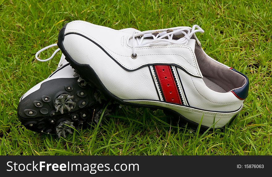 Golf shoes on grass field