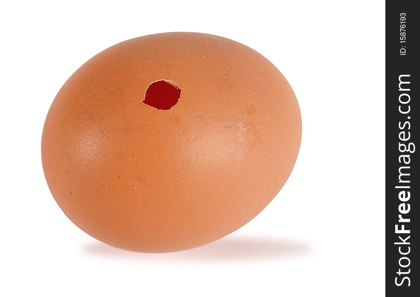 Small hole in an egg isolated over white. Small hole in an egg isolated over white.