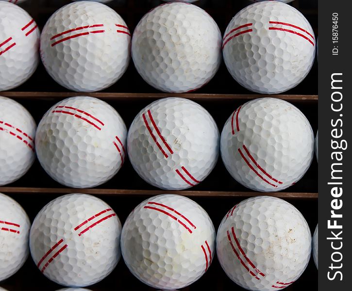 Golf balls on tray ready to drive