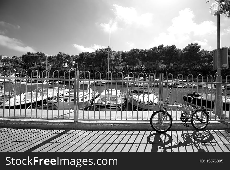 Monochrome image oÐ° summer embankment with geometric shadows ang lonely bicycle