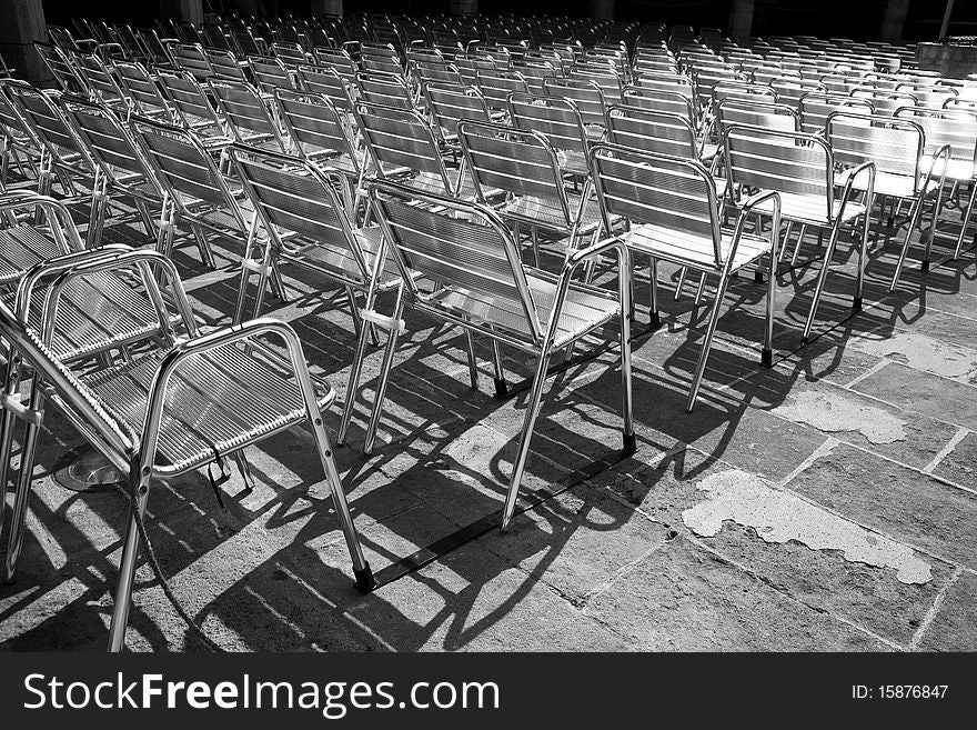 Auditorium full of shiny metal chairs