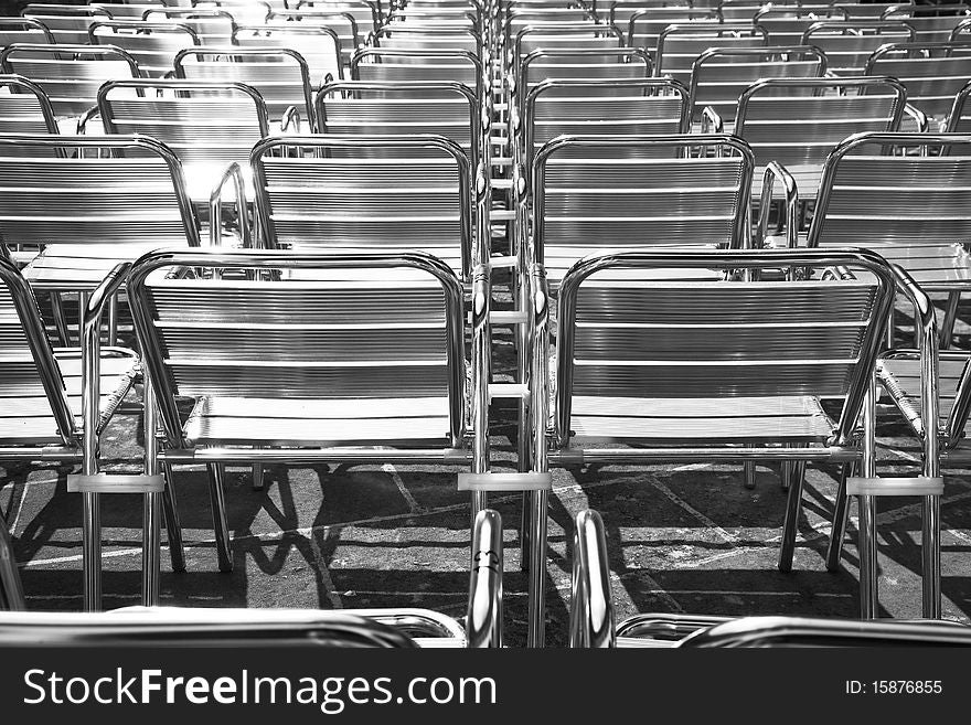 Auditorium full of shiny metal chairs background. Auditorium full of shiny metal chairs background